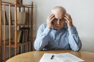 Depressed worried man looking at a form