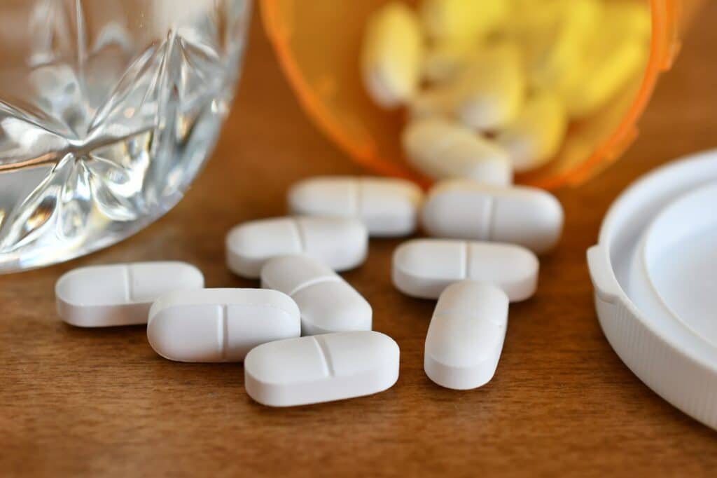 Narcotic opioid pain pills by prescription bottle.